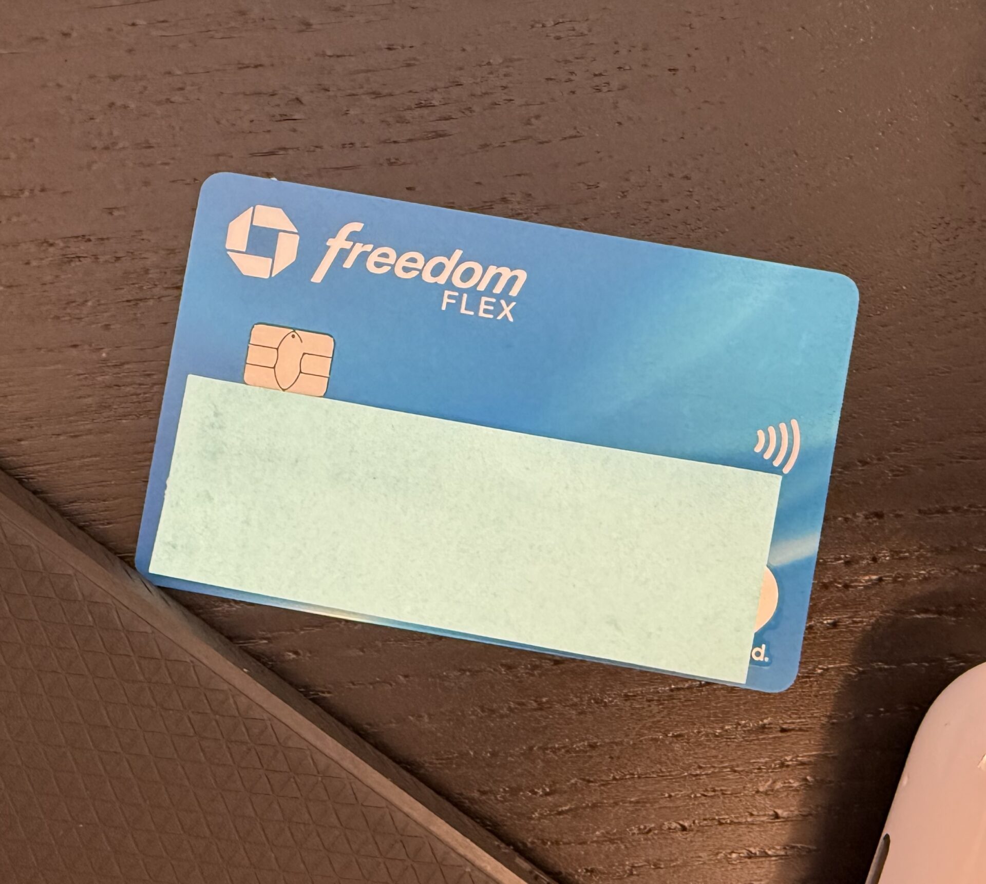 Photo of a Chase Freedom Flex credit card with the number, expiration date, and name covered up.